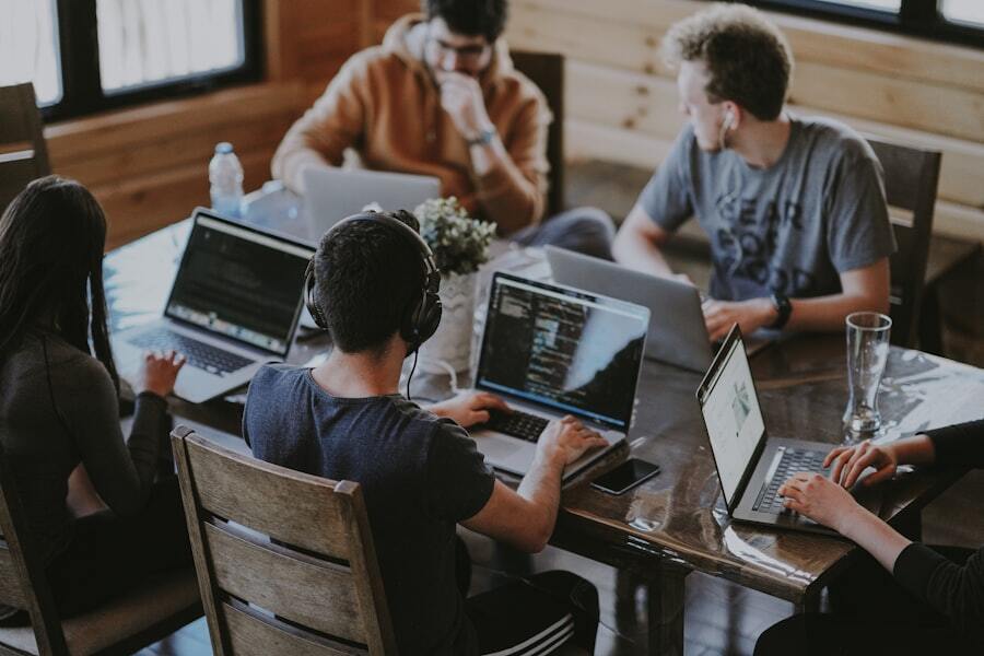 The Clipping Beast production team working on professional photo editing projects in a modern studio with 40+ editors providing 24/7 image editing services.